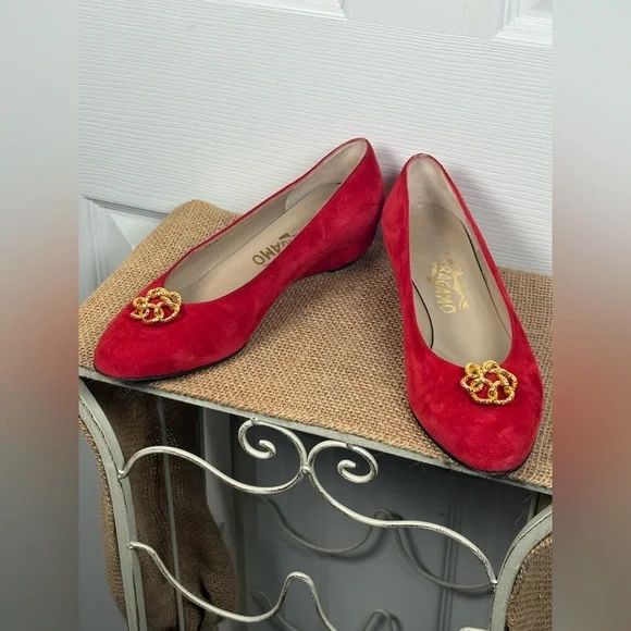 Salvatore Ferragamo red suede pumps featuring a gold-toned ornamental buckle